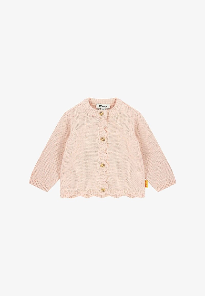 Světle růžový pletený cardigan s dlouhými rukávy, vlnitým lemem a čtyřmi zlatými knoflíky. Na boku se nachází štítek.