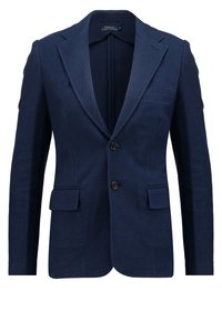 Blazer bleu marine en tissu texturé. Caractéristiques : revers cranté, deux poches avant et deux boutons. L'intérieur est non doublé.