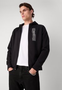Calvin Klein HORIZONTAL LOGO ZIP THRU HOODIE - Mikina so zipsom - black