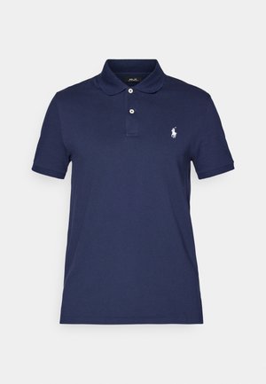 Navy polo shirt made of cotton, featuring a classic collar, two-button placket, and a small white logo on the left chest. Short sleeves.