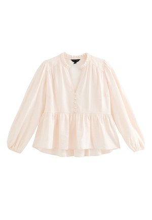 Blouse rose clair avec un col à volants, boutonnée devant et manches longues. Ourlet peplum, tissu texturé et détails froncés aux épaules.