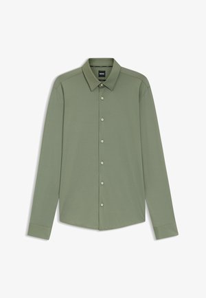 Langarmshirt van olijfgroene stof met een kraag. Beschikt over een knoopsluiting aan de voorkant en manchet mouwen. Smoother textuur.