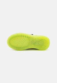 Bright yellow rubber sole with a honeycomb pattern, featuring subtle traction grooves and branding. Sleek, rounded shape designed for comfort.