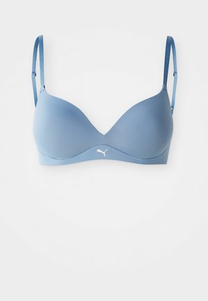 Light blue padded bra with adjustable straps and a smooth texture. Features a white logo on the center band. Classic design with a seamless finish.
