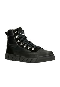 Zwarte high-top sneakers met een leren en suedine bovenmateriaal, voorzien van metalen oogjes, zwarte veters en een dikke, geprofileerde rubberen zool.