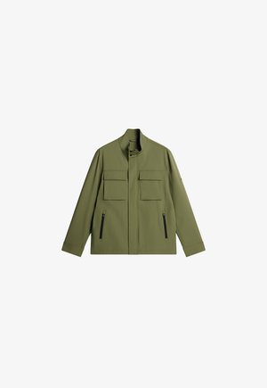 Olive green jacket with a high collar, two chest pockets, and two black zippered side pockets. Made from smooth, textured fabric.