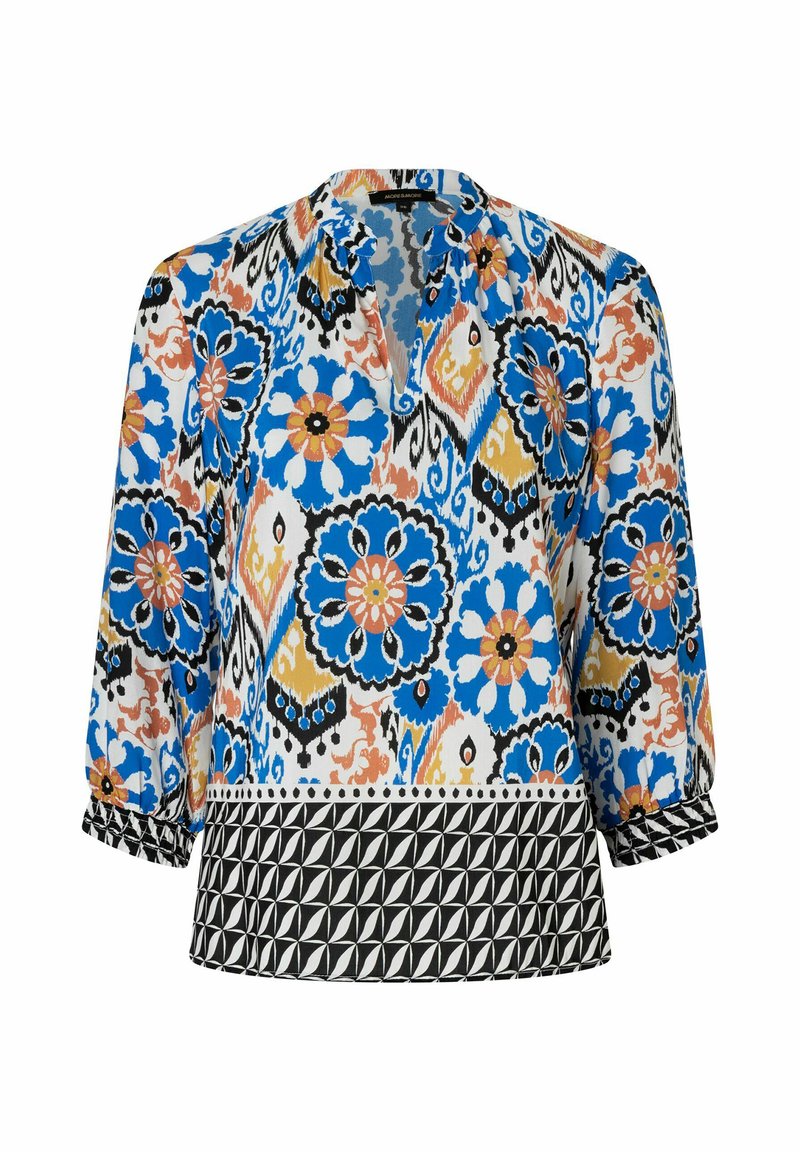 Bunt gemusterte Bluse mit floralen Motiven in Blau, Orange und Schwarz, mit Dreiviertelärmeln und einem schwarzen geometrischen Band am Saum.