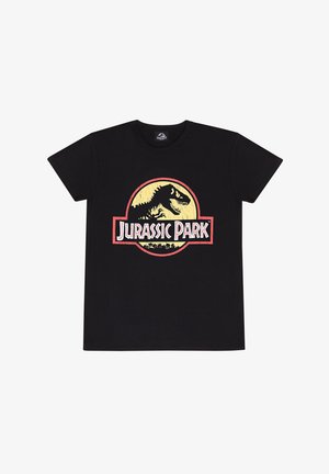 Camiseta de algodón negra con un gran gráfico circular del logo de Jurassic Park en rojo y amarillo, que incluye la silueta de un dinosaurio y texto.