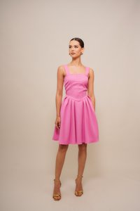 Rosa, ärmelloses Kleid mit tailliertem Oberteil und weit ausgestelltem Rock. Hergestellt aus strukturiertem Stoff, mit breiten Trägern und Falten-Details.