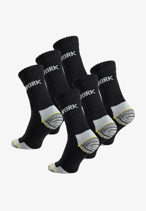 Chaussettes de travail noires avec texture côtelée, arborant "WORK" en lettres blanches, des accents gris au niveau des orteils et des talons, et des détails jaunes au niveau des talons.