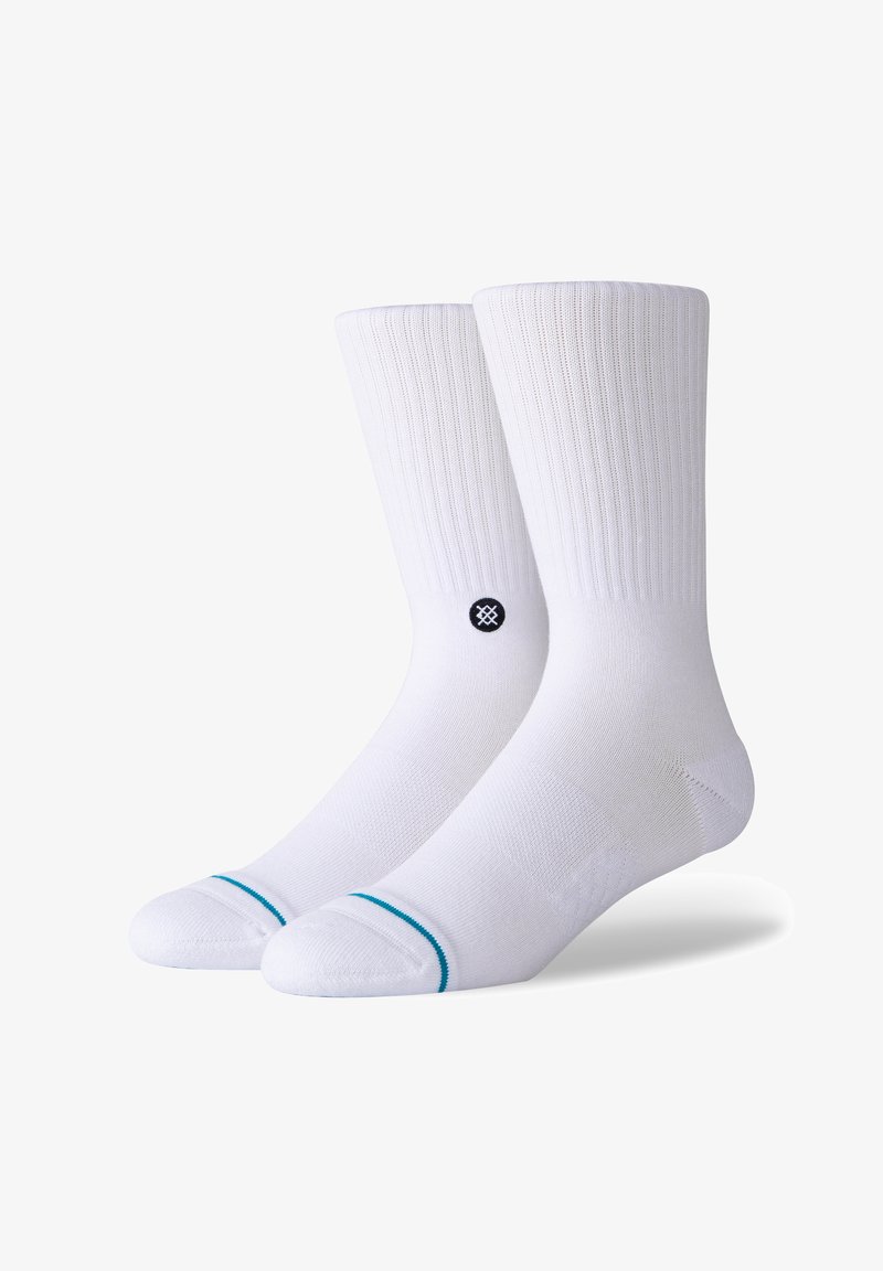 White cushioned socks with ribbed texture, featuring a contrasting turquoise stripe at the top and a circular black logo on the side.