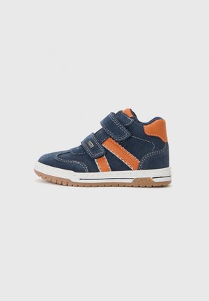 Navy blue suede high-top shoe with orange accents, featuring two velcro straps, white stitching, and a rubber outsole for grip.