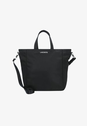 Borsa tote nera Lacoste realizzata in tessuto morbido, con manici corti, tracolla regolabile e logo sul davanti.