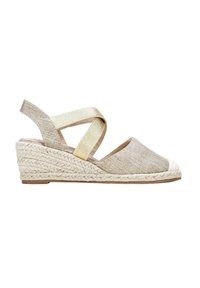 Beige fabric wedge sandals with a textured upper, gold cross-strap accent, and woven jute sole. Rounded toe and low heel profile.
