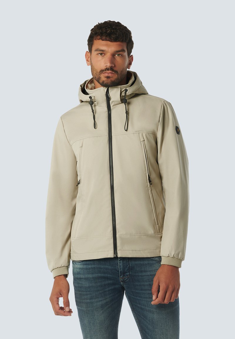 Beige gewatteerde jas met een rits aan de voorkant, twee zijzakken en een trekkoord in de capuchon. Glad materiaal met een ontspannen pasvorm.