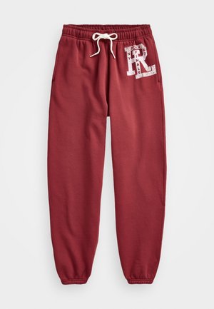 Pantaloni della tuta color granata con vita elastica e polsini, coulisse bianca, tasche laterali e logo bianco stampato sull'anca sinistra.