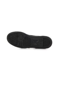 Semelle de sneaker noire en caoutchouc texturé pour une bonne adhérence, présentant des motifs hexagonaux, une empreinte circulaire et des lignes de profil distinctes pour la traction.