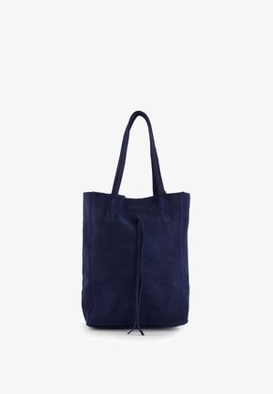 Navy blue suede tote bag with two shoulder straps and a front center drawstring detail, standing upright on a white background.