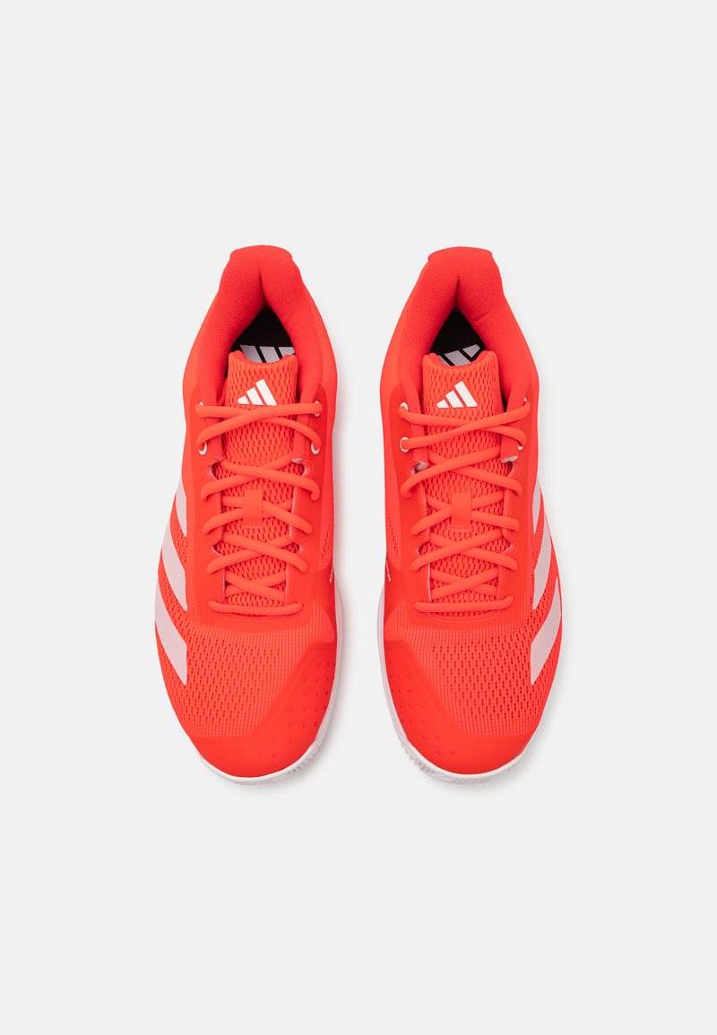 Rote Sportschuhe mit einem Mesh-Obermaterial, leichtem Design, runder Zehenpartie und weißen Akzenten mit drei Streifen an den Seiten.