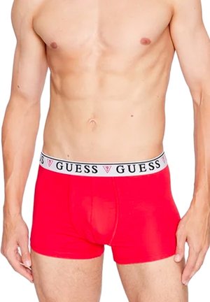 Rote Herren-Boxershorts mit einem weißen elastischen Bund, der ein schwarzes "GUESS"-Logo trägt. Glattes Material mit tailliertem Design.