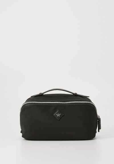 Black nylon travel bag featuring a rectangular shape, top handle, silver zipper, and a small diamond-shaped logo on the front.