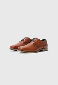 Brown leather dress shoes with a smooth finish, rounded toe, and black laces. Features a contrasting dark heel and subtle stitching accents.