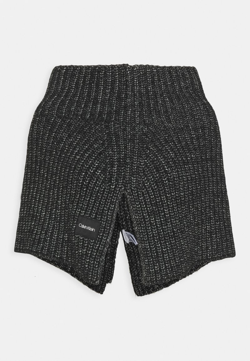 Tour de cou en tricot côtelé noir et gris avec étiquette Calvin Klein cousue à l'avant, plié pour afficher la texture du tissu à l'intérieur.