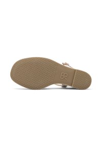 Sole di sandalo beige con un design testurizzato e a motivi. Presenta una forma arrotondata con un logo del marchio impresso sull'area del tallone.
