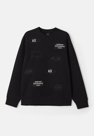 Black sweatshirt featuring various embroidered patches, including logo designs and text, with a crew neckline and long sleeves.
