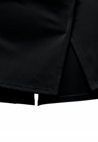 Black athletic shorts featuring a smooth, lightweight fabric, with a split hem design and visible stitching details.
