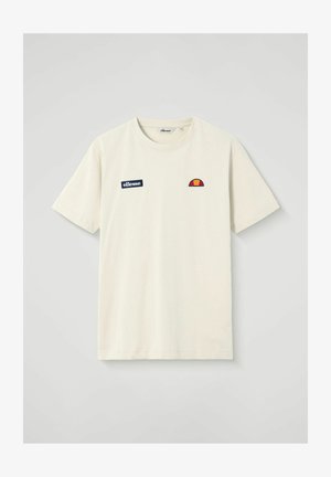 T-shirt crème à manches courtes avec col rond, présentant un patch texte "ellesse" en bleu marine et un logo en demi-cercle rouge-orange sur la poitrine.