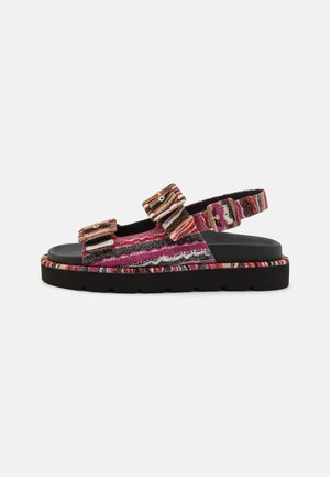 Textured sandals with multicolored fabric straps, two adjustable buckles, and a black chunky sole. Features horizontal stripes in pink, white, and orange.