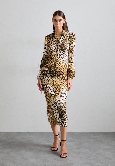 Long-sleeve, leopard print dress in shades of yellow, brown, and white, features a button-up front and a fitted silhouette.