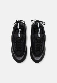 Black athletic shoes with a textured upper, lace-up front, and reflective accents. Curved sole and padded collar for added comfort.