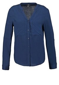 Blouse bleu marine à manches longues avec boutons, deux poches poitrine et un col rond sans col.