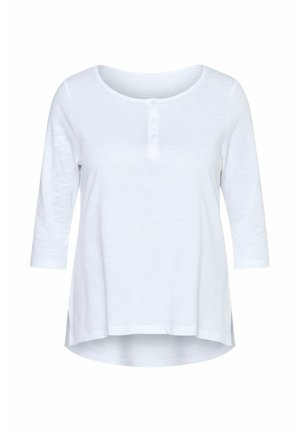 Biała, długorękawowa bluzka wykonana z miękkiego materiału. Posiada zaokrąglony dekolt oraz patkę z trzema białymi guzikami. Zaokrąglony dół z bocznymi rozcięciami.