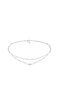 Silver double-layered necklace featuring delicate chains with small round beads and a star-shaped pendant. Smooth texture and polished finish.