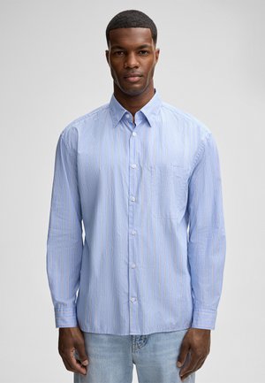 Light blue button-up shirt with vertical white and orange stripes, single chest pocket, long sleeves, and soft fabric texture.
