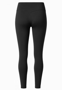 Zwarte leggings gemaakt van rekbaar materiaal, met een hoge tailleband en een aansluitend ontwerp met platte naden voor comfort. Geen zichtbare patronen.