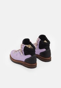 Purple suede hiking boots with black accents, silver hardware, and textured rubber soles, featuring a padded collar and contrasting stitching.