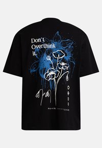 Black cotton t-shirt featuring blue and white floral graphic with the text "Don't Overthink it" on the back, relaxed fit, short sleeves.