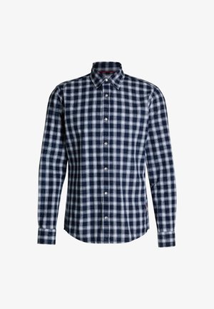 Koszula w kratę w granatowym i białym kolorze z bawełnianej tkaniny, z kołnierzykiem zapinanym na guziki, długimi rękawami i zaokrąglonym dołem z zapięciami na guziki.