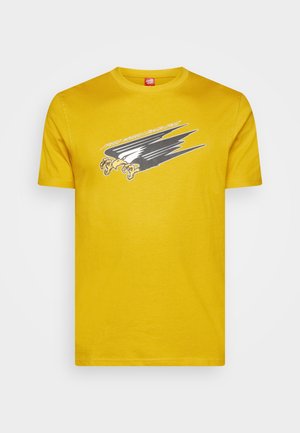 T-shirt en coton jaune avec un col rond, présentant un imprimé graphique d'un aigle et des lignes dynamiques en noir et gris sur le devant.