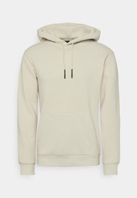 Felpa con cappuccio beige realizzata in morbido tessuto. Presenta una tasca a marsupio, polsini a costine e lacci regolabili con punte nere.