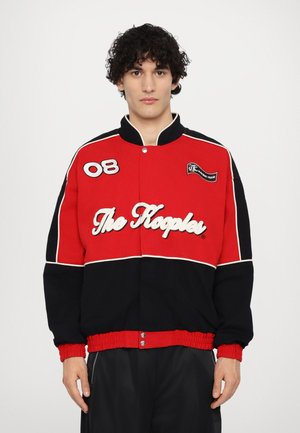 Red and black bomber jacket featuring an embroidered logo, number "08" on the left, and elastic cuffs and hem. Soft, textured fabric.