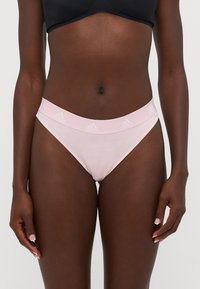 Light pink underwear with a soft texture and a wide elastic waistband featuring subtle Adidas branding. Designed for comfort and fit.