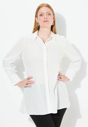 Witte longsleeve overhemd met knopen, gemaakt van lichtgewicht stof, met een klassieke kraag en zijsplitten voor gemakkelijk bewegen.