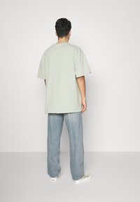 Weekday GALAXY LOOSE STRAIGHT UNISEX - Calças de ganga folgadas - light worned blue