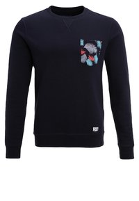 Marineblaues Sweatshirt mit Rundhalsausschnitt, strukturierter Oberfläche, gerippte Bündchen und Saum, ausgestattet mit einer gemusterten Tasche mit hellblauen und roten Blättern.