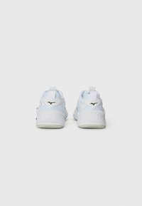 White athletic shoes with a textured back, green accents, and a black logo. Features a padded collar and a flexible sole design.
